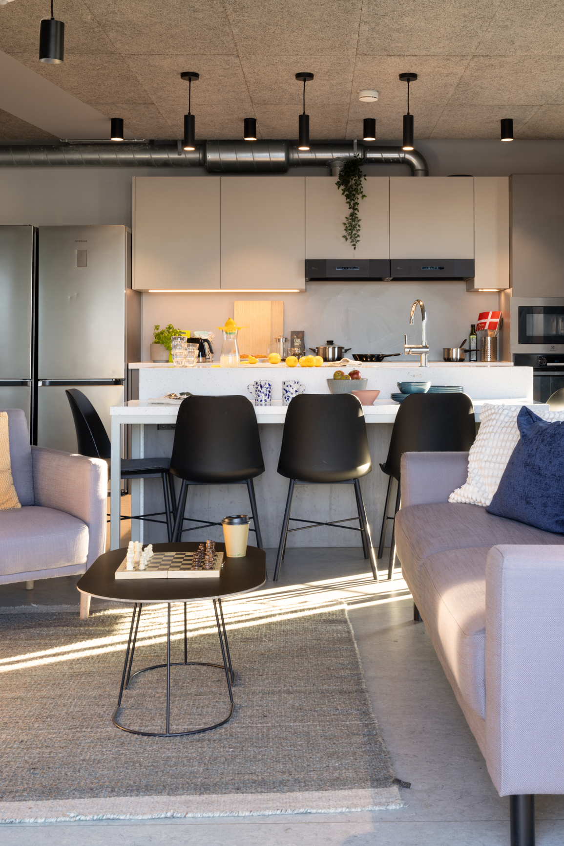 Common kitchen island and living area in Basestack Bryggen student accommodation and apartments to rent in Copenhagen